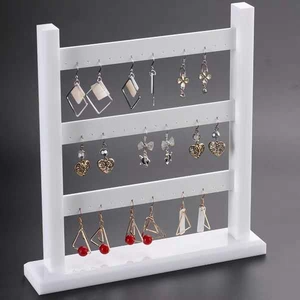 Three-tier white acrylic earring display stand with multiple hanging holes for jewelry