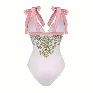 Detail of V-neck one-piece swimsuit with floral print and pink satin bow straps