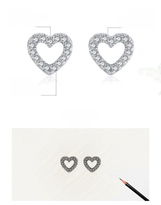 Detailed macro of 925 sterling silver heart stud earrings with white micro-pave zircons