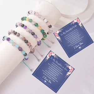 Adjustable natural stone bead bracelets with heart charms on display with gift cards
