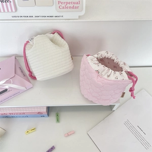 Close-up of quilted cotton drawstring pouch with floral lining and pink heart pattern
