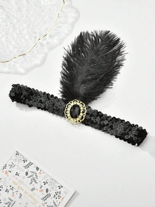 Detailed view of vintage black sequin headband with fluffy feathers and gemstone detail