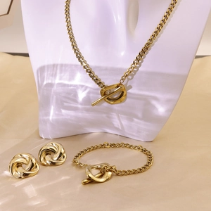 Detailed view of vintage gold chain jewelry set with OT clasps and twist earrings