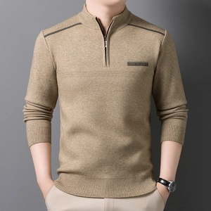 Detail of camel half-zip knit sweater showing shoulder stitching and ribbed cuffs