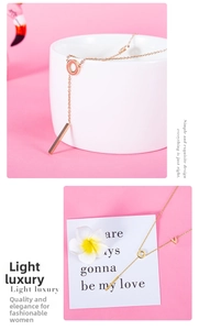 Detail of rose gold titanium LOVE necklace with geometric rings and V-shaped accents