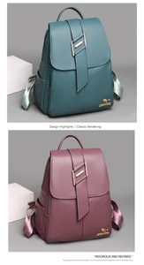 Detail of dark cyan and burgundy lychee grain leather backpacks with kangaroo metal logo
