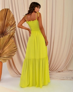 Detailed back view of a fluorescent yellow maxi dress with elegant elastic smocked waist