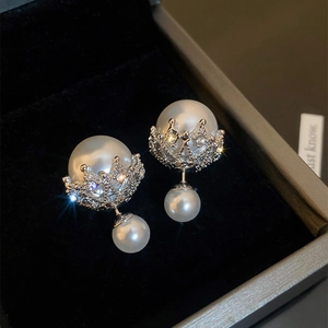 Macro detail of elegant crown pearl stud earrings with sparkling crystal accents