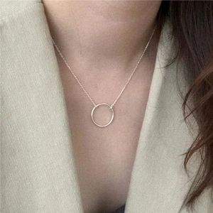 Minimalist S925 silver circle pendant necklace styled with a beige blazer for office wear