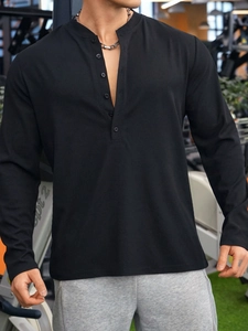 Close-up of black waffle knit fabric on a men's slim-fit long sleeve Henley polo shirt