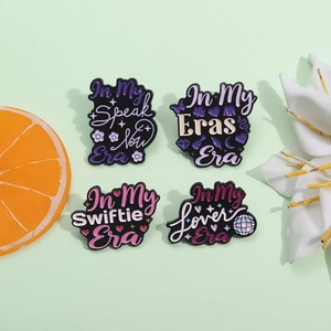 Set of four Taylor Swift era enamel pins including Speak Now and Lover themes