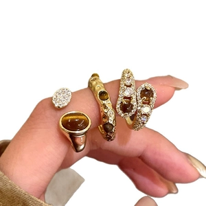 Vintage 4-piece gold plated ring set featuring brown tiger eye stone and bohemian style