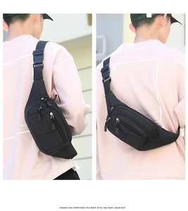 Close-up of black nylon waist bag with multiple zipper compartments and durable buckle
