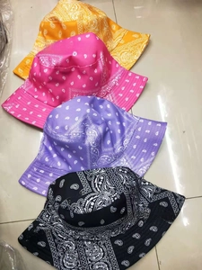 Close-up of reversible paisley fisherman hats in yellow, pink, purple and black
