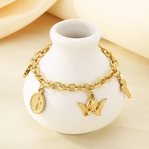Detailed close-up of 18K gold plated chain bracelet with angel and cross charms