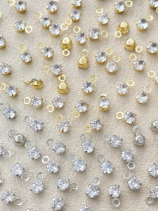 Macro shot of gold and silver plated zircon pendant connectors for DIY jewelry making