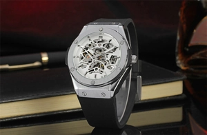 Detail of silver skeleton automatic watch dial showing intricate mechanical movement gears