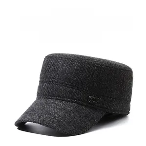 Close-up of gray textured wool fabric and metal 'R' logo on the flat top winter cap