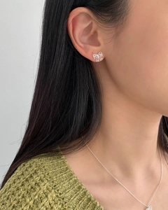 925 silver bow stud earrings and matching necklace set worn by a female model