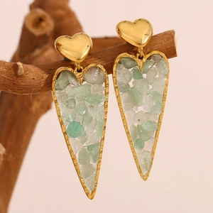 18K gold-plated stainless steel heart earrings with green stones on a wooden branch