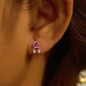 Close-up of S925 sterling silver earring with triangle ruby and hanging bead detail