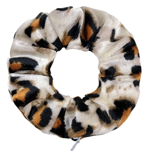 Detail shot of leopard print velvet hair scrunchie with functional zipper pocket