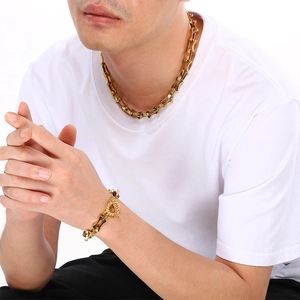 Male model wearing gold hip-hop bamboo link chain necklace and bracelet with T-bar clasp
