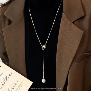 Adjustable 62cm gold chain pearl necklace shown on clothing for length and styling reference