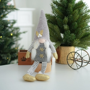 Close-up of a grey and gold Christmas gnome doll in a cozy festive home setting