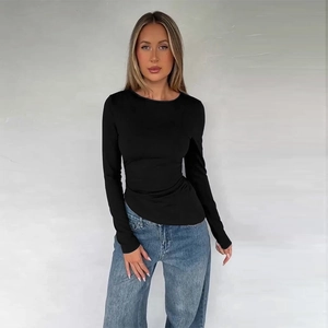 Close-up of black slim fit long sleeve top with an asymmetrical hem and soft knit texture