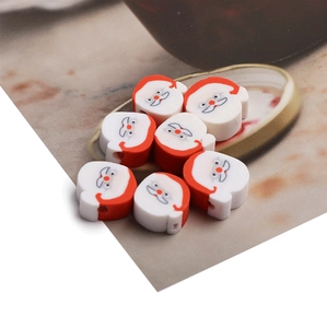 Detailed view of 8 handmade polymer clay Santa Claus beads for Christmas DIY jewelry