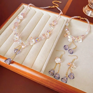 Floral crystal tassel necklace and earring set with pink beaded heart charms