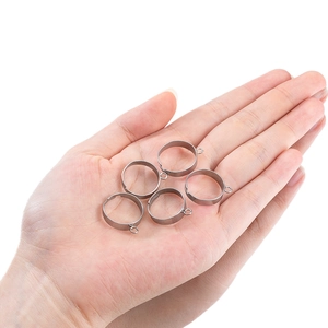 Adjustable silver stainless steel flat ring bases held in palm for DIY jewelry making