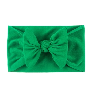 Soft bright green nylon baby headband with a large handmade bow for infants