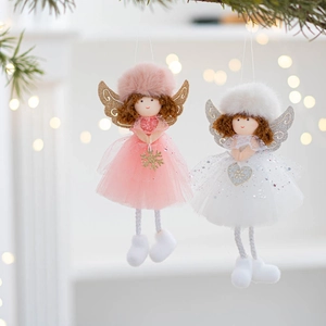 Detail of plush Christmas angel dolls with tulle skirts and golden glittery snowflake accents