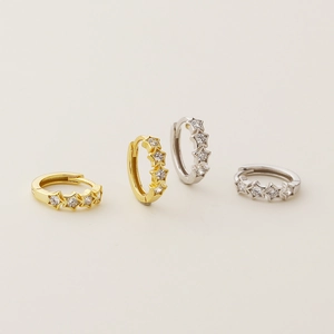 S925 silver star hoop earrings with crystals in gold and silver finish on light background