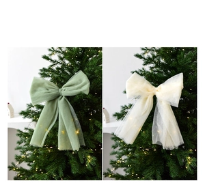 Detailed view of large organza Christmas tree bows in sage green and cream white colors