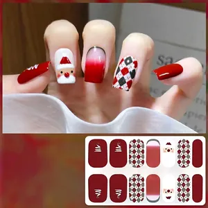 Detail of Christmas nail stickers featuring Santa Claus and red checkered patterns