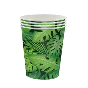Detail of disposable paper cups with tropical monstera and palm leaf prints for jungle parties