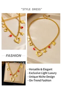 Detailed close-up of gold stainless steel necklace with heart and red drop pendants