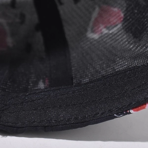 Macro shot of baseball cap inner rim with reinforced stitching and red heart print