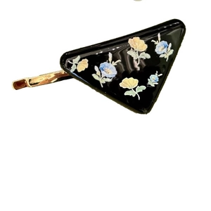 Triangle hair clip with light blue floral pattern on black base in spring style