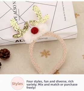 Detail view of plush reindeer headband with golden glitter antlers and red pom pom nose