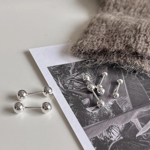 Macro shot of 925 sterling silver ball stud earrings with a high-polished mirror finish