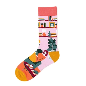 Detail of pink cotton socks featuring home life illustrations with yellow heel and toe