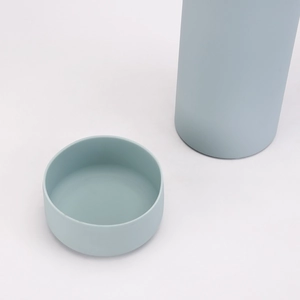 Close-up of a matte light blue 1L thermal flask with lid showing modern design detail