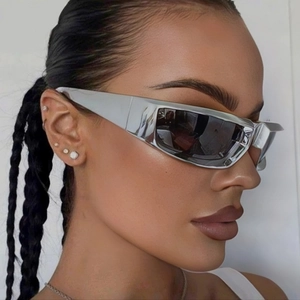 Silver Y2K futuristic punk sunglasses with metallic wrap-around frame on female model