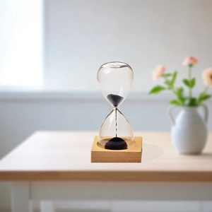 Creative magnetic hourglass with black iron filings and wooden base on a desk