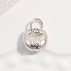 Macro shot of silver Fu character lock pendant with detailed cloud pattern and ring