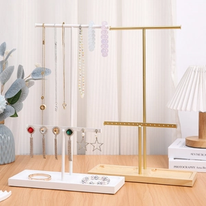 Elegant gold and white iron jewelry stand with wooden base for earring and necklace storage